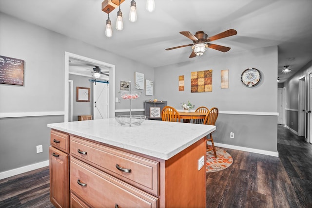 211 S E St, Hudson, IL 61748 - kitchen with a ceiling fan, dark wood-style floors, brown cabinetry, and baseboards