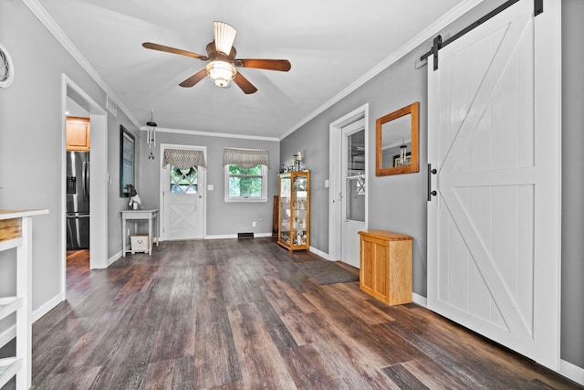 211 S E St, Hudson, IL 61748 - entryway featuring a barn door, a ceiling fan, wood finished floors, baseboards, and ornamental molding