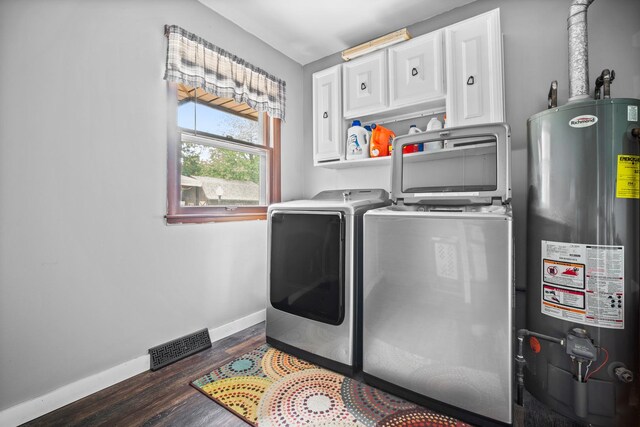 211 S E St, Hudson, IL 61748 - laundry room featuring gas water heater, cabinet space, washing machine and dryer, baseboards, and wood finished floors