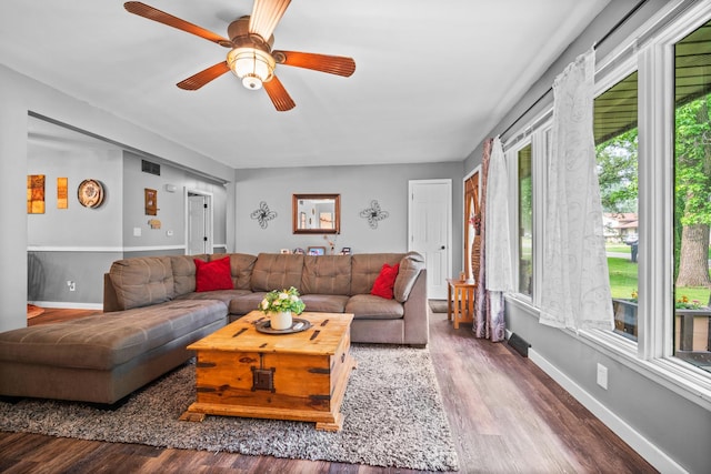 211 S E St, Hudson, IL 61748 - living room with wood finished floors, ceiling fan, and baseboards
