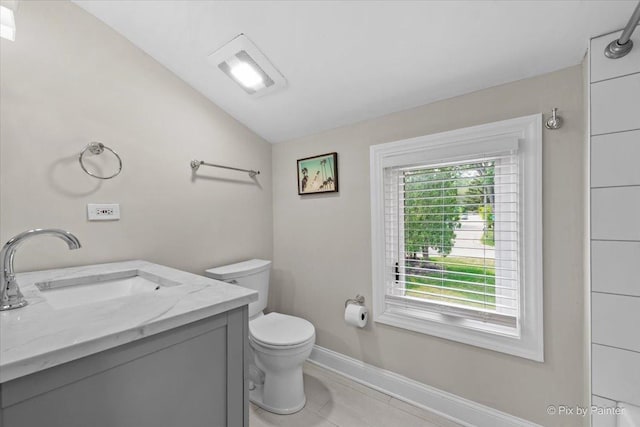 1599 Lowe Dr, Algonquin, IL 60102 - bathroom with toilet, vaulted ceiling, baseboards, vanity, and tile patterned flooring