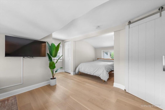 1599 Lowe Dr, Algonquin, IL 60102 - bedroom featuring a barn door, wood finished floors, and baseboards