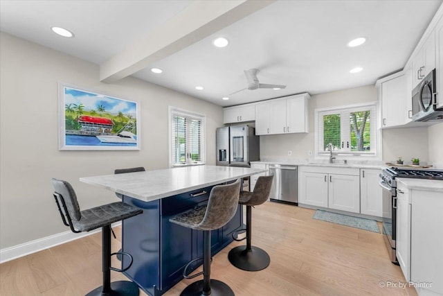 1599 Lowe Dr, Algonquin, IL 60102 - kitchen with stainless steel appliances, a sink, a breakfast bar, recessed lighting, and white cabinets