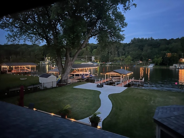 1599 Lowe Dr, Algonquin, IL 60102 - dock area featuring boat lift, a view of trees, a water view, and a lawn
