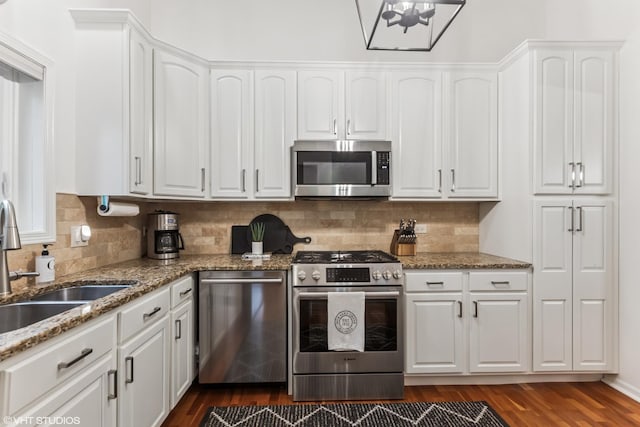 4400 Pershing Ave Unit 3S, Downers Grove, IL 60515 - kitchen featuring stainless steel appliances, a sink, white cabinets, dark wood finished floors, and backsplash