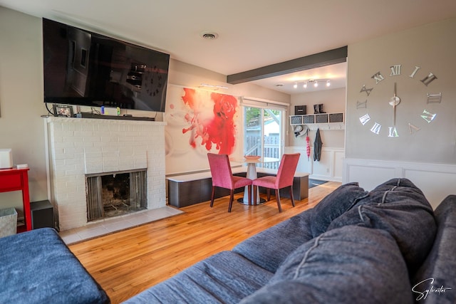 545 Delaware Dr, Lake In The Hills, IL 60156 - living area with wood finished floors, a fireplace, and wainscoting