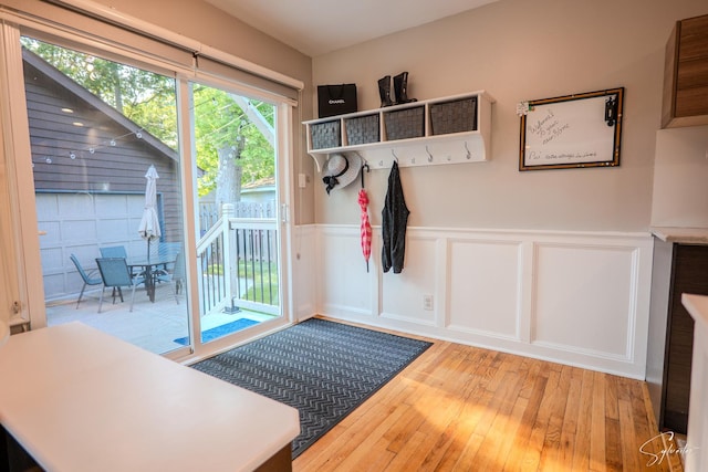 545 Delaware Dr, Lake In The Hills, IL 60156 - entryway with light wood-style floors, a wainscoted wall, and a decorative wall