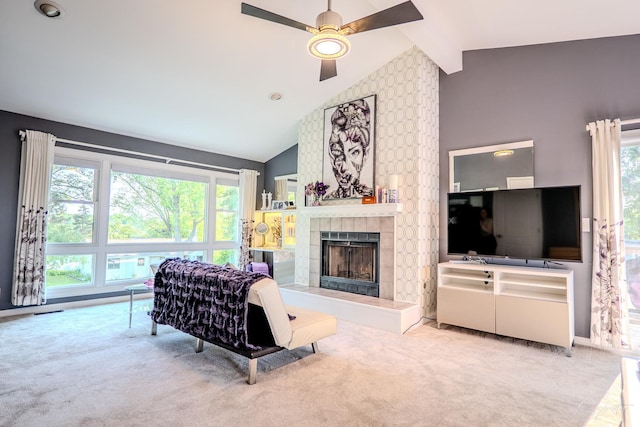 545 Delaware Dr, Lake In The Hills, IL 60156 - carpeted living area with ceiling fan, a tiled fireplace, healthy amount of natural light, and high vaulted ceiling