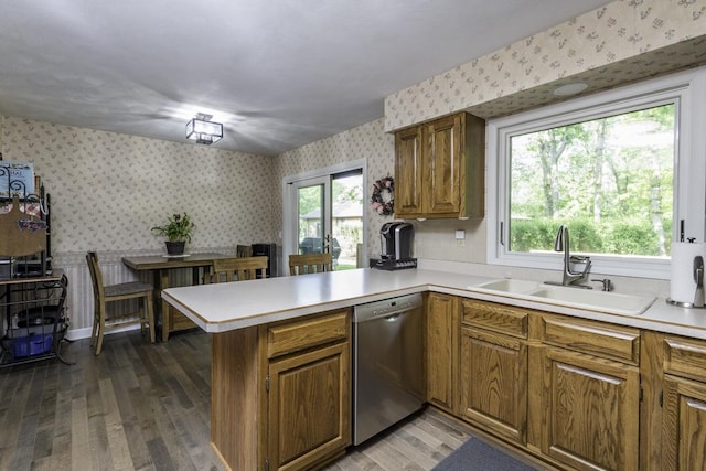 1401 Funderburk Dr, Winthrop Harbor, IL 60096 - kitchen featuring dishwasher, wallpapered walls, a sink, a peninsula, and brown cabinets