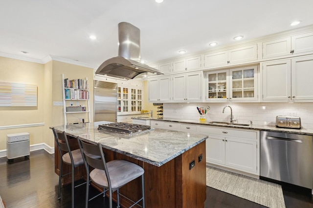 3500 N Lake Shore Dr Unit 5D, Chicago, IL 60657 - kitchen with stainless steel appliances, island range hood, dark wood-style floors, a kitchen island, and ornamental molding