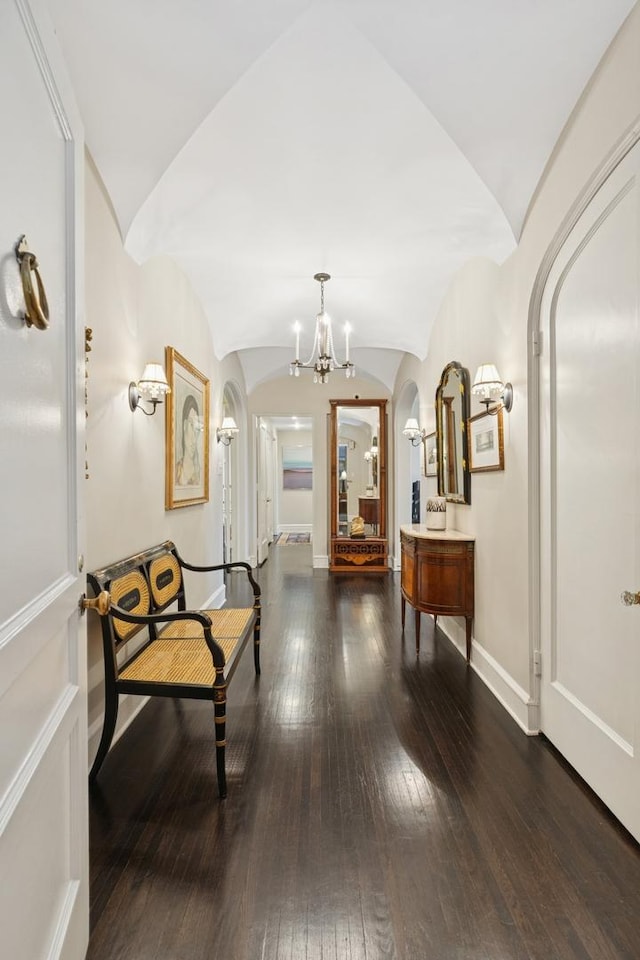 3500 N Lake Shore Dr Unit 5D, Chicago, IL 60657 - hallway with arched walkways, wood-type flooring, and a chandelier