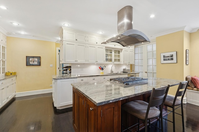 3500 N Lake Shore Dr Unit 5D, Chicago, IL 60657 - kitchen with island range hood, crown molding, dark wood-style flooring, a center island, and stainless steel gas cooktop