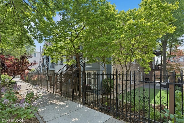 2319 W Shakespeare St, Chicago, IL 60647 - view of front of house featuring a fenced front yard and stairway