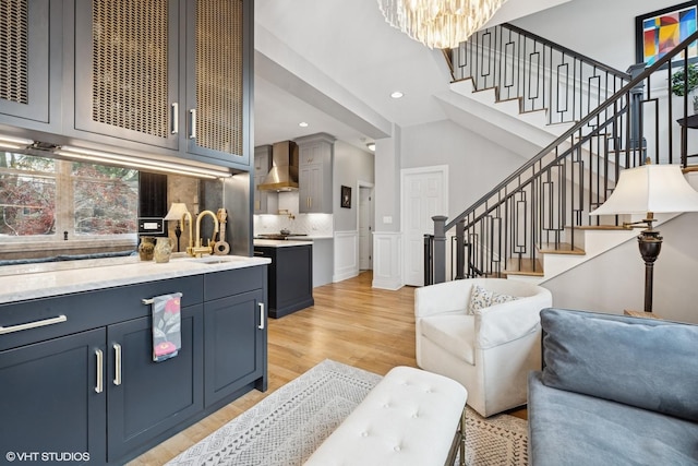 2319 W Shakespeare St, Chicago, IL 60647 - living room featuring stairs, light wood-style floors, a chandelier, and recessed lighting