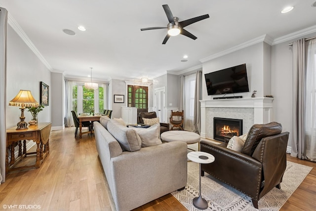2319 W Shakespeare St, Chicago, IL 60647 - living area featuring light wood-style floors, a glass covered fireplace, ornamental molding, ceiling fan, and recessed lighting
