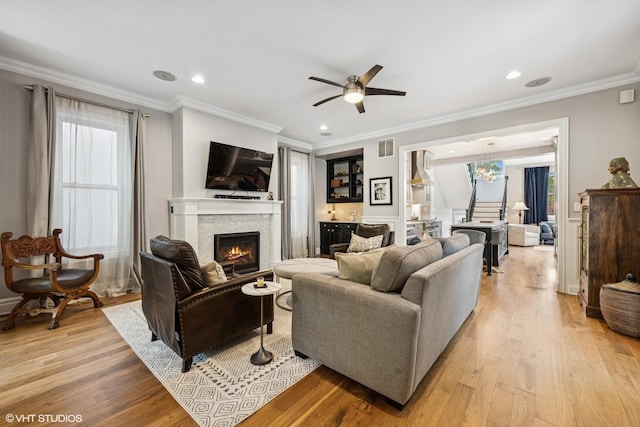 2319 W Shakespeare St, Chicago, IL 60647 - living room with a lit fireplace, light wood-type flooring, a ceiling fan, ornamental molding, and recessed lighting