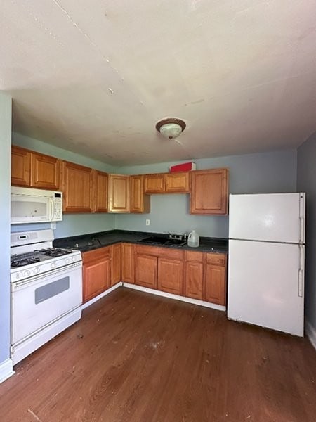 1764 Ross Cres, Sauk Village, IL 60411 - kitchen featuring white appliances, dark wood-type flooring, a sink, dark countertops, and brown cabinets