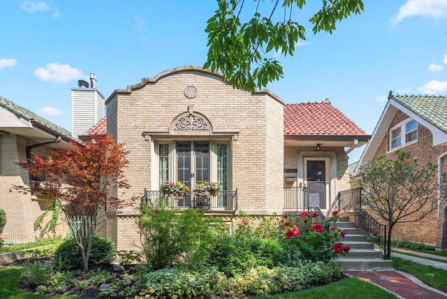 2530 W Morse Ave, Chicago, IL 60645 - view of front of property featuring brick siding, a tiled roof, and covered porch