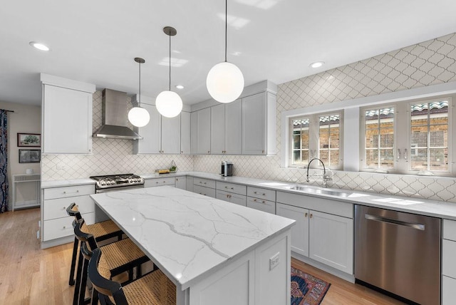 2530 W Morse Ave, Chicago, IL 60645 - kitchen featuring dishwasher, wall chimney range hood, tasteful backsplash, a center island, and light wood finished floors