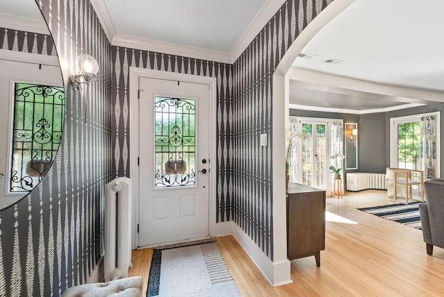 2530 W Morse Ave, Chicago, IL 60645 - entryway featuring radiator, wood finished floors, ornamental molding, wallpapered walls, and a chandelier