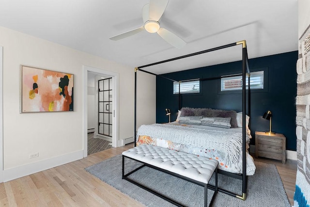 2530 W Morse Ave, Chicago, IL 60645 - bedroom featuring wood finished floors, a baseboard heating unit, baseboard heating, and a ceiling fan