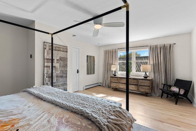 2530 W Morse Ave, Chicago, IL 60645 - bedroom with a baseboard radiator, wood finished floors, and a ceiling fan