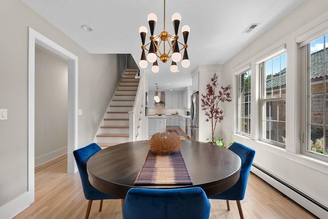 2530 W Morse Ave, Chicago, IL 60645 - dining room featuring a baseboard radiator, light wood-style flooring, stairway, a chandelier, and recessed lighting