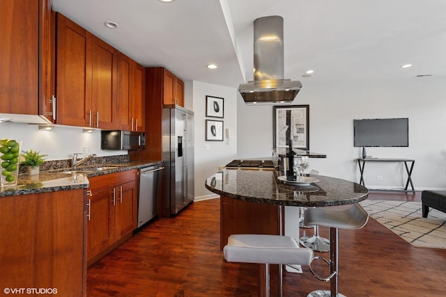 2315 W Wabansia Ave Unit 3Ne, Chicago, IL 60647 - kitchen featuring stainless steel appliances, island exhaust hood, a sink, a kitchen bar, and dark wood-style floors