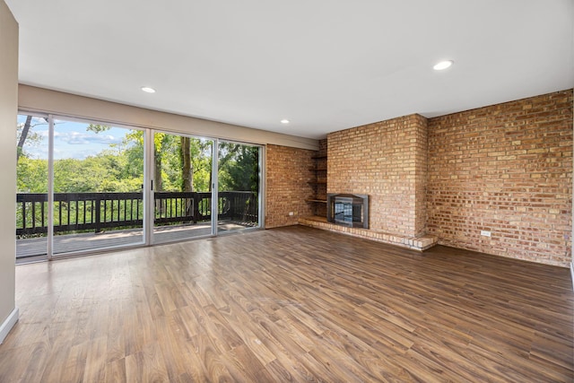5515 Lakeside Dr Unit 1D, Lisle, IL 60532 - unfurnished living room featuring wood finished floors, a brick fireplace, recessed lighting, and brick wall
