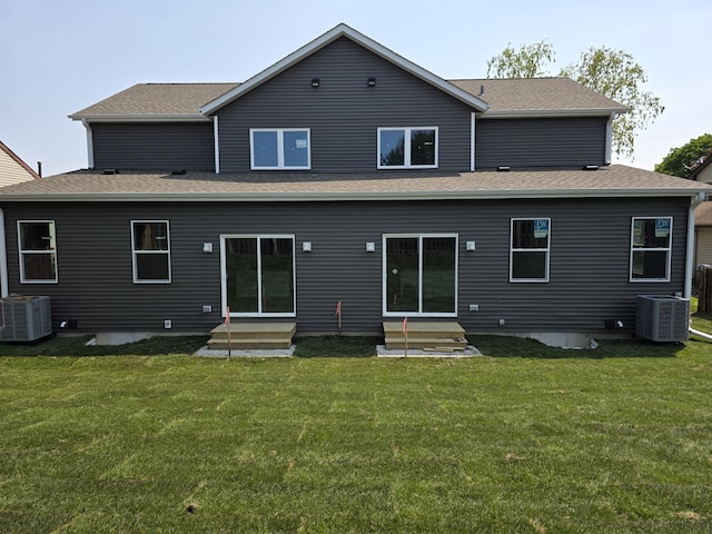 1390 Merrimac Ln, Hanover Park, IL 60133 - back of property with entry steps, central AC unit, a yard, and a shingled roof