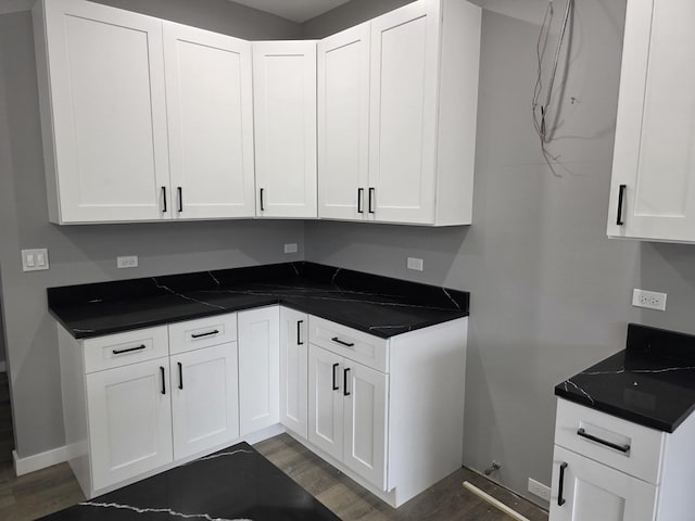 1390 Merrimac Ln, Hanover Park, IL 60133 - kitchen with white cabinets, dark countertops, dark wood-type flooring, and baseboards