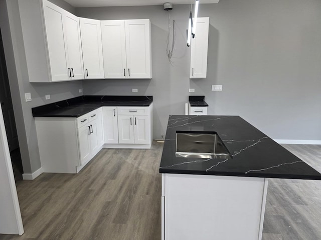 1390 Merrimac Ln, Hanover Park, IL 60133 - kitchen featuring wood finished floors, dark countertops, white cabinetry, and baseboards