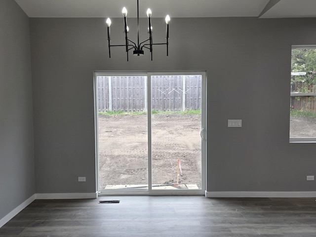1390 Merrimac Ln, Hanover Park, IL 60133 - unfurnished dining area featuring wood finished floors, a chandelier, and baseboards