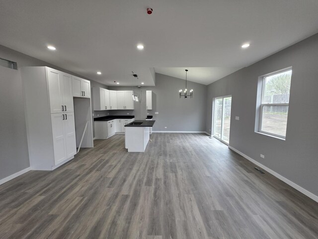 1390 Merrimac Ln, Hanover Park, IL 60133 - kitchen featuring open floor plan, a chandelier, baseboards, dark countertops, and vaulted ceiling