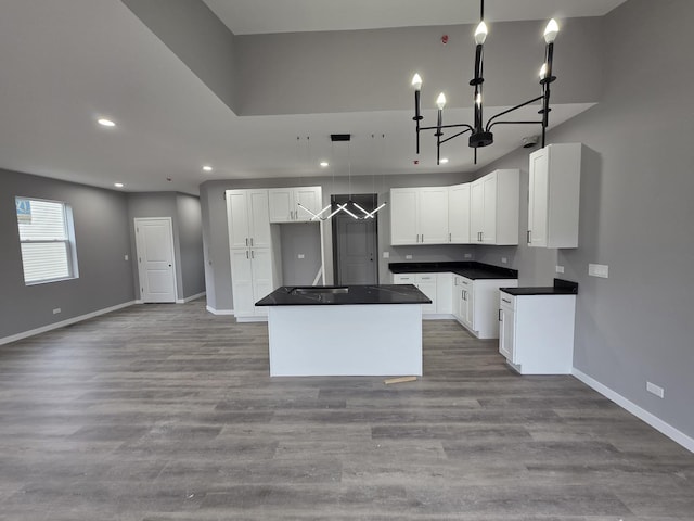 1390 Merrimac Ln, Hanover Park, IL 60133 - kitchen featuring a center island, dark countertops, recessed lighting, baseboards, and a chandelier