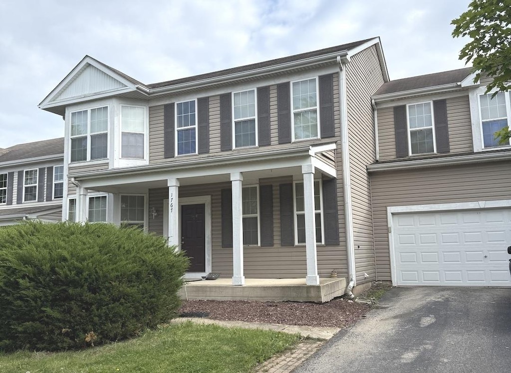 1767 Shari Ln, Aurora, IL 60504 - view of front facade with a porch, a garage, and driveway