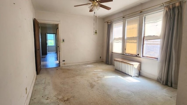 5330 W Foster Ave, Chicago, IL 60630 - spare room featuring radiator, a ceiling fan, and unfinished concrete floors