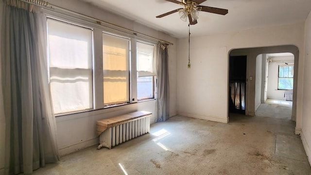 5330 W Foster Ave, Chicago, IL 60630 - unfurnished room with radiator, ceiling fan, arched walkways, and concrete floors