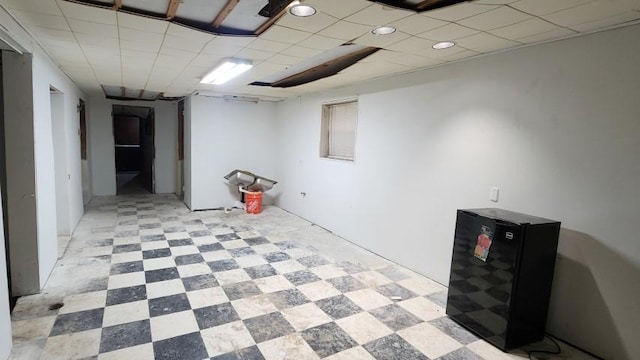 5330 W Foster Ave, Chicago, IL 60630 - finished below grade area with light floors, fridge, and a paneled ceiling