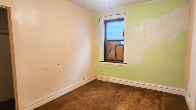 5330 W Foster Ave, Chicago, IL 60630 - spare room featuring dark colored carpet and baseboards