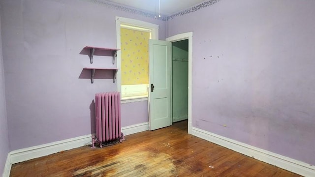 5330 W Foster Ave, Chicago, IL 60630 - empty room with radiator and wood finished floors