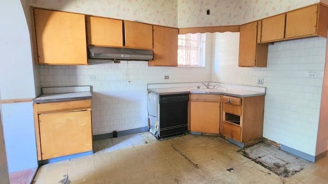 5330 W Foster Ave, Chicago, IL 60630 - kitchen with under cabinet range hood, wallpapered walls, dishwasher, light countertops, and decorative backsplash