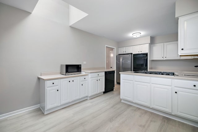 6231 W 127th Pl, Palos Heights, IL 60463 - kitchen with black appliances, light wood-type flooring, white cabinets, and light countertops