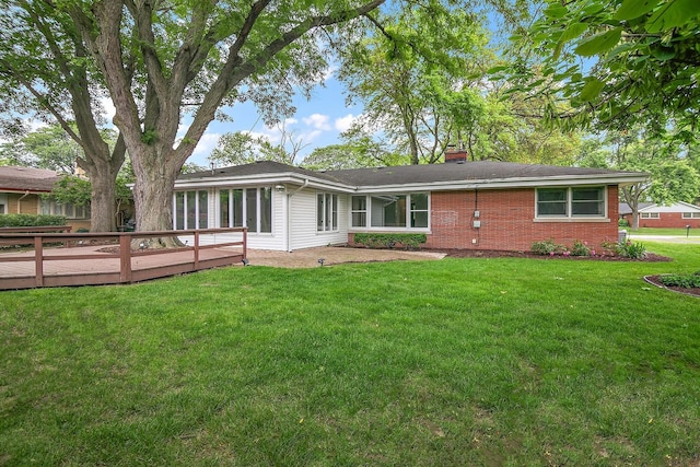 6231 W 127th Pl, Palos Heights, IL 60463 - back of property featuring a chimney, a deck, brick siding, and a lawn