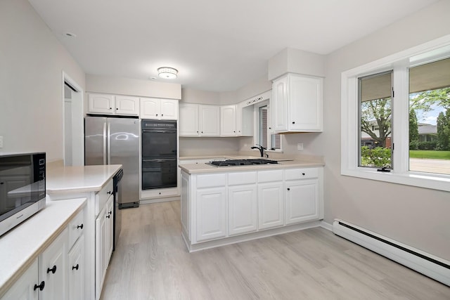 6231 W 127th Pl, Palos Heights, IL 60463 - kitchen with baseboard heating, stainless steel appliances, light wood-style flooring, and light countertops