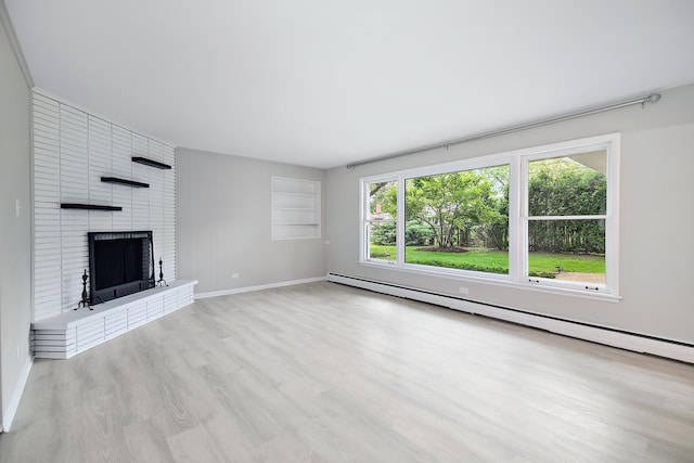 6231 W 127th Pl, Palos Heights, IL 60463 - unfurnished living room featuring light wood-style flooring, a brick fireplace, and a baseboard heating unit