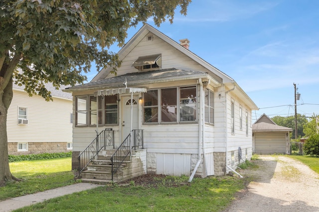 1207 Oakland Ave, Joliet, IL 60435 - view of front of property featuring a chimney, a front yard, driveway, and cooling unit