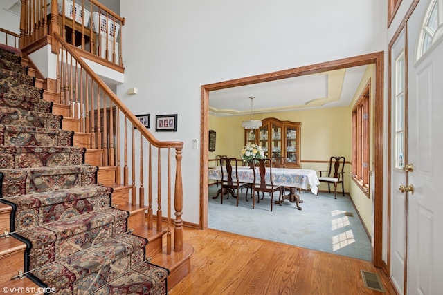 17935 Pheasant Lake Dr, Tinley Park, IL 60487 - foyer featuring stairway, wood finished floors, a high ceiling, carpet floors, and baseboards