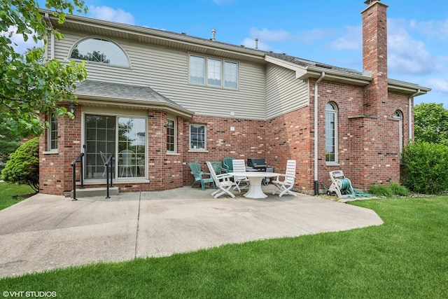17935 Pheasant Lake Dr, Tinley Park, IL 60487 - back of property with a chimney, a patio, a yard, and brick siding