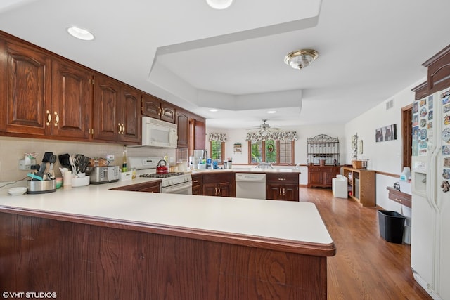 17935 Pheasant Lake Dr, Tinley Park, IL 60487 - kitchen featuring white appliances, a peninsula, a ceiling fan, light countertops, and wood finished floors